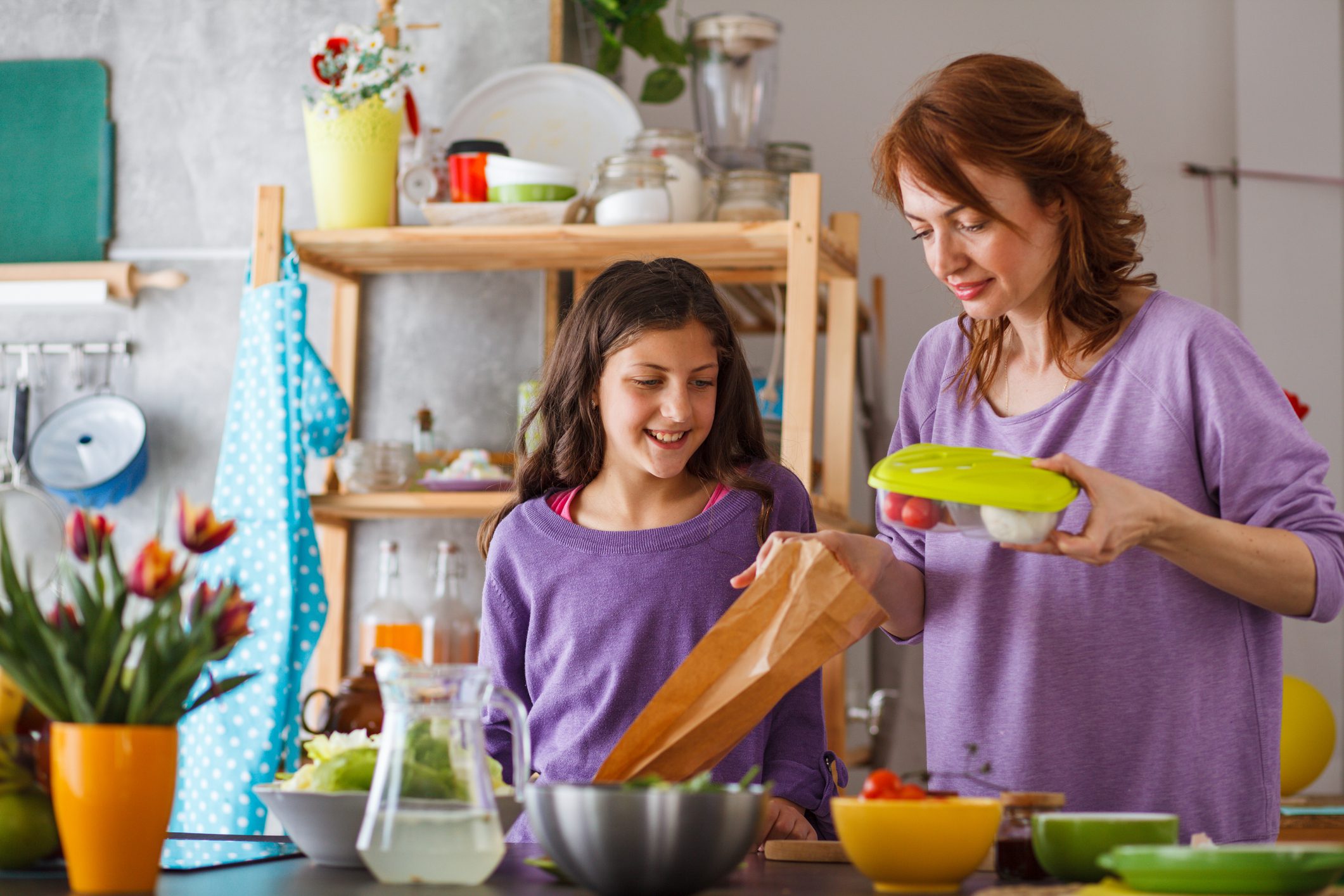 Mother packing school lunch for her daughter