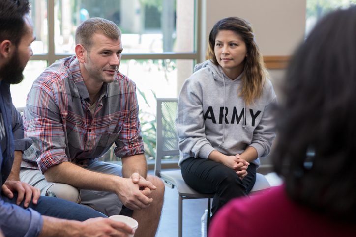 a group of veterans sitting in a circle having meaningful conversation